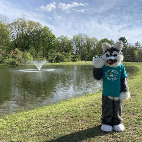 mascot standing in front of pond